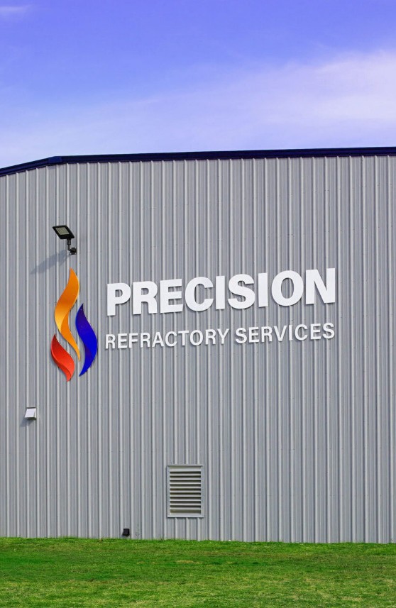 Gray industrial building with a logo and 
